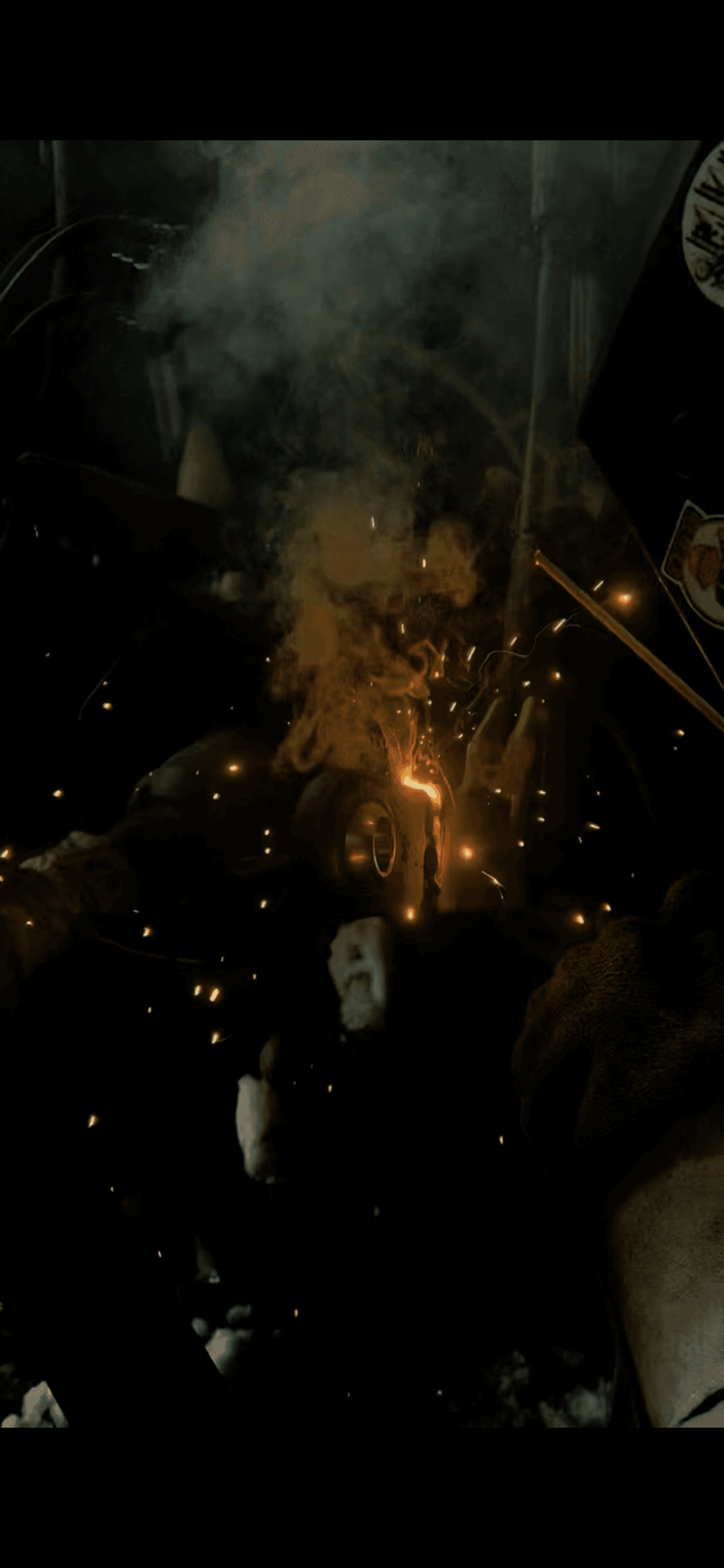 Intense welding on metal parts, producing bright orange light, sparks, and thick rising smoke.